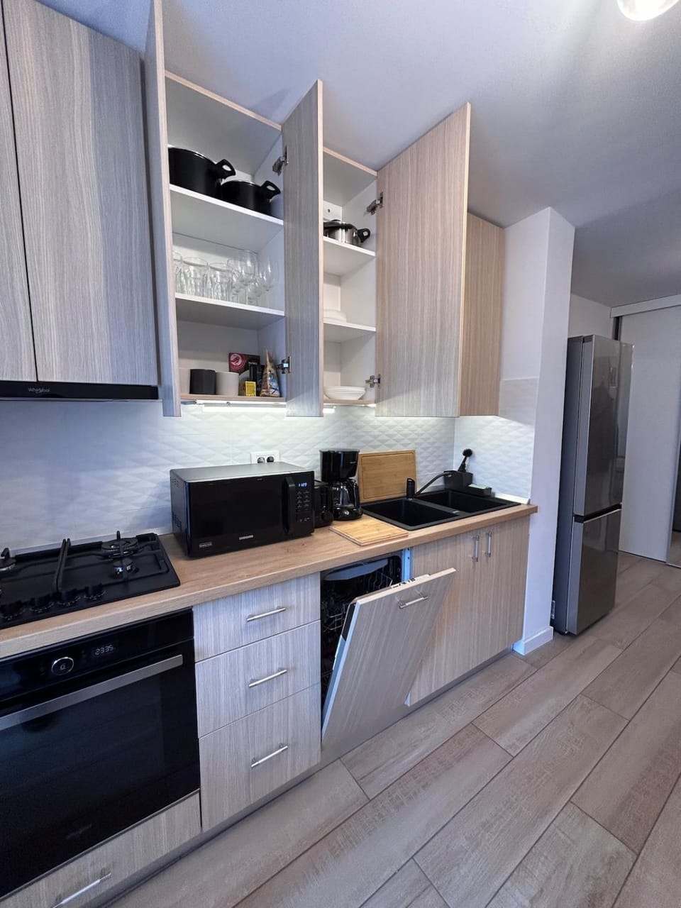 Kitchen or kitchenette, dishwasher, oven, stove