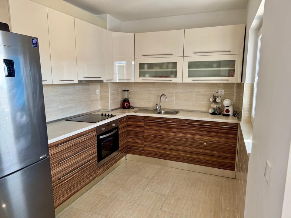 Kitchen or kitchenette, dishwasher, oven, stove