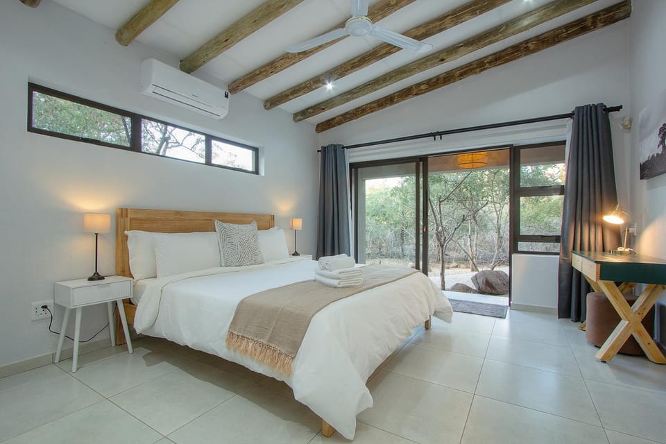 Bed, Photo of the whole room, Bedroom, hair dryier, towels, air conditioner