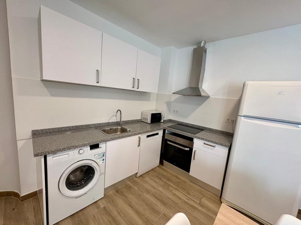 Kitchen or kitchenette, dishwasher, oven, stove, washing machine