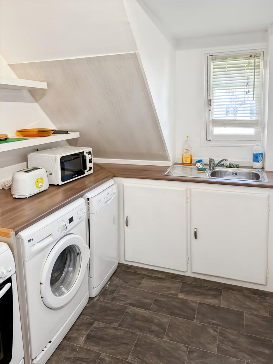 Kitchen or kitchenette, dishwasher, oven, stove, toaster, washing machine