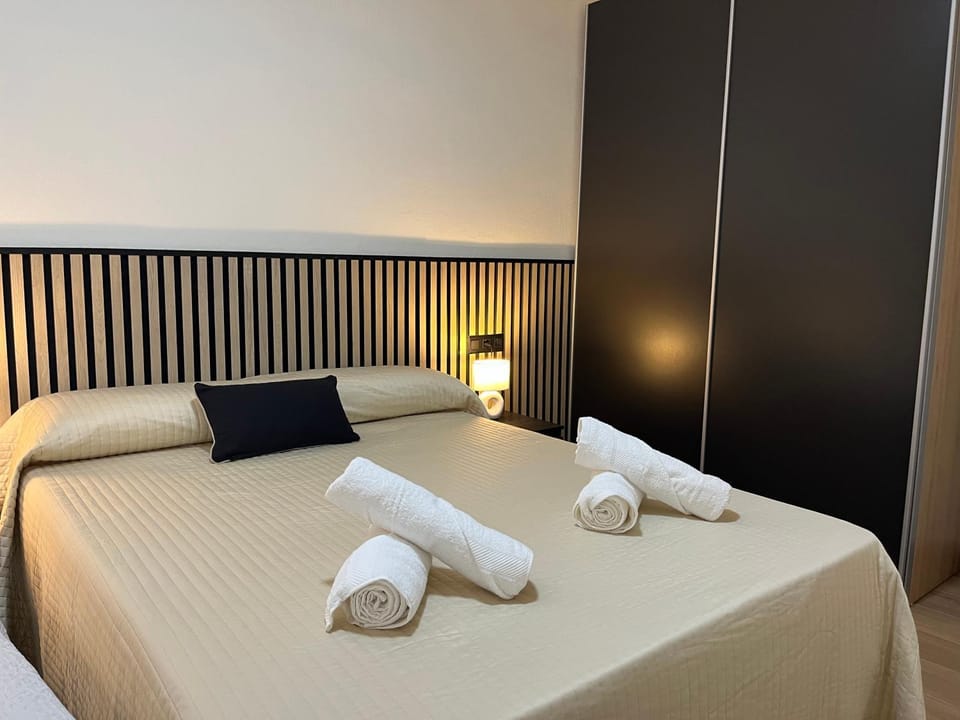 Bed, towels, wardrobe