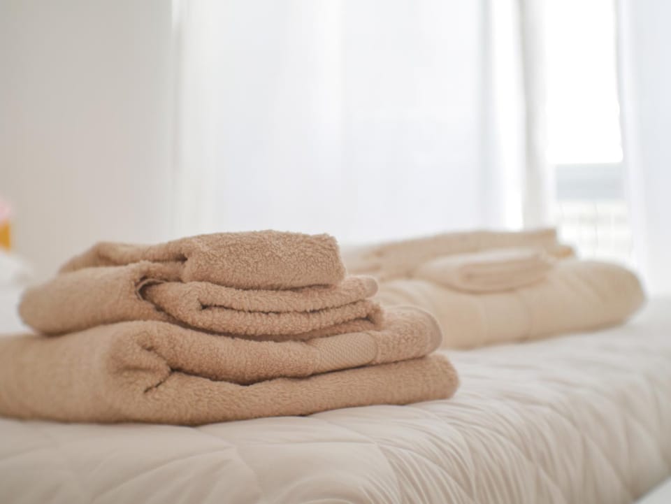 Bed, hair dryier, towels