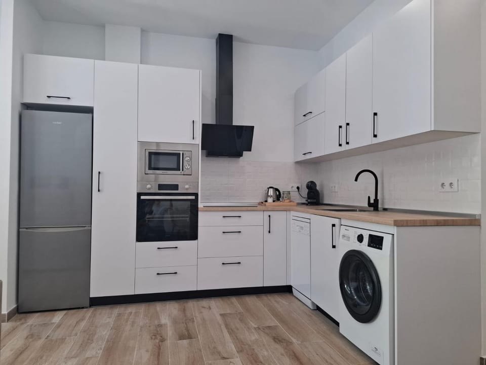 Kitchen or kitchenette, dishwasher, oven, stove, toaster, washing machine