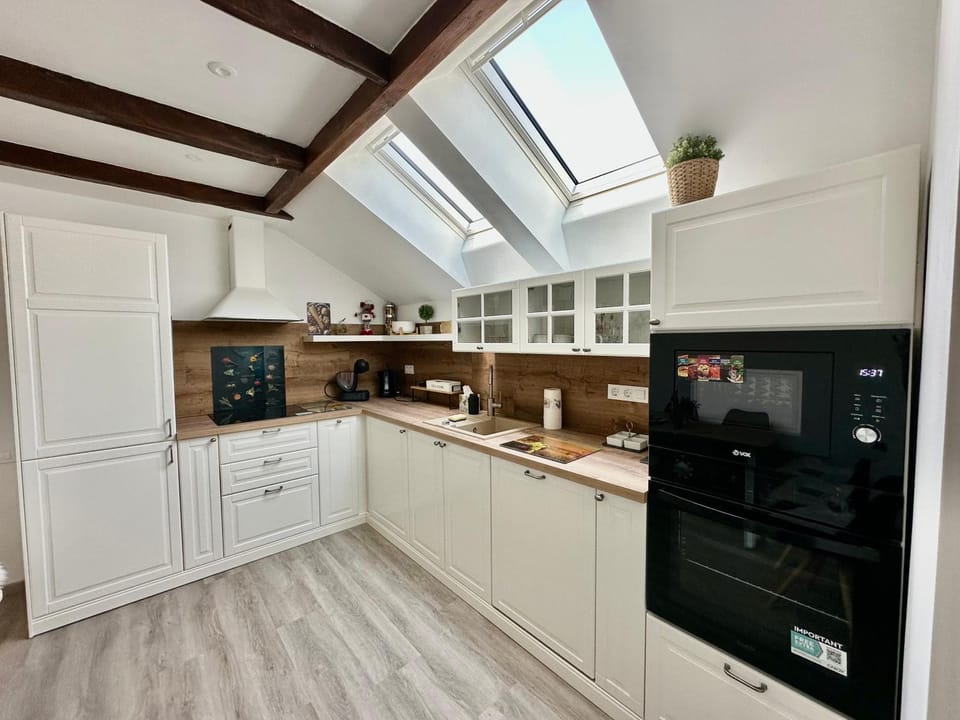 Kitchen or kitchenette, dishwasher, oven, stove
