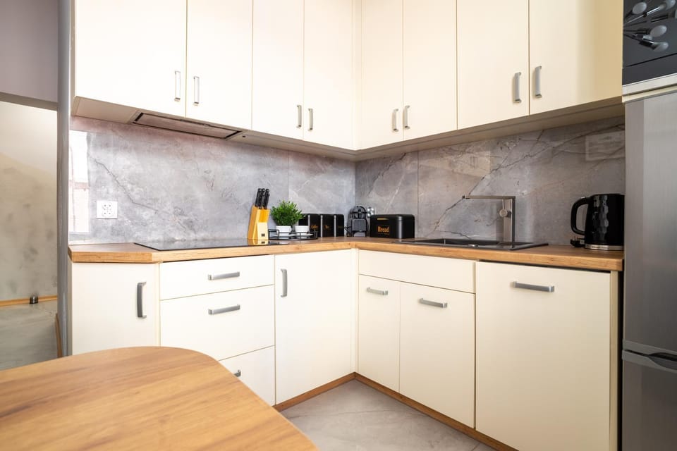 Kitchen or kitchenette, dishwasher, oven, stove