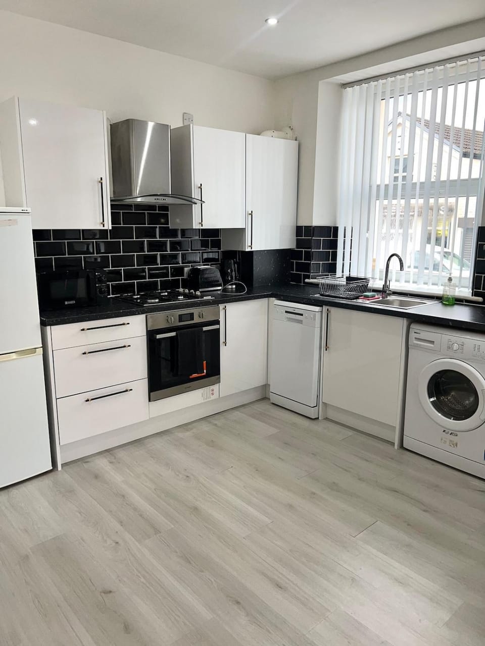 Kitchen or kitchenette, dishwasher, oven, stove