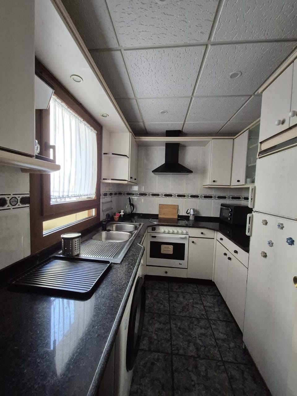 Kitchen or kitchenette, microwave, oven, stove, toaster, washing machine