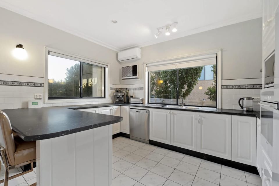Kitchen or kitchenette, dishwasher, stove, air conditioner