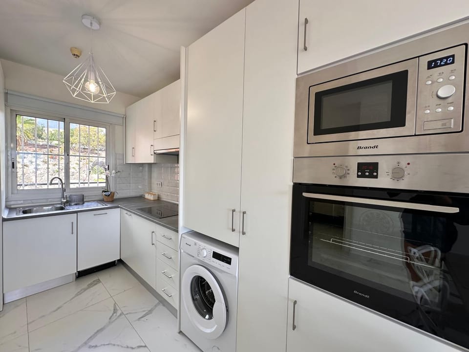 Kitchen or kitchenette, dishwasher, oven, stove, washing machine