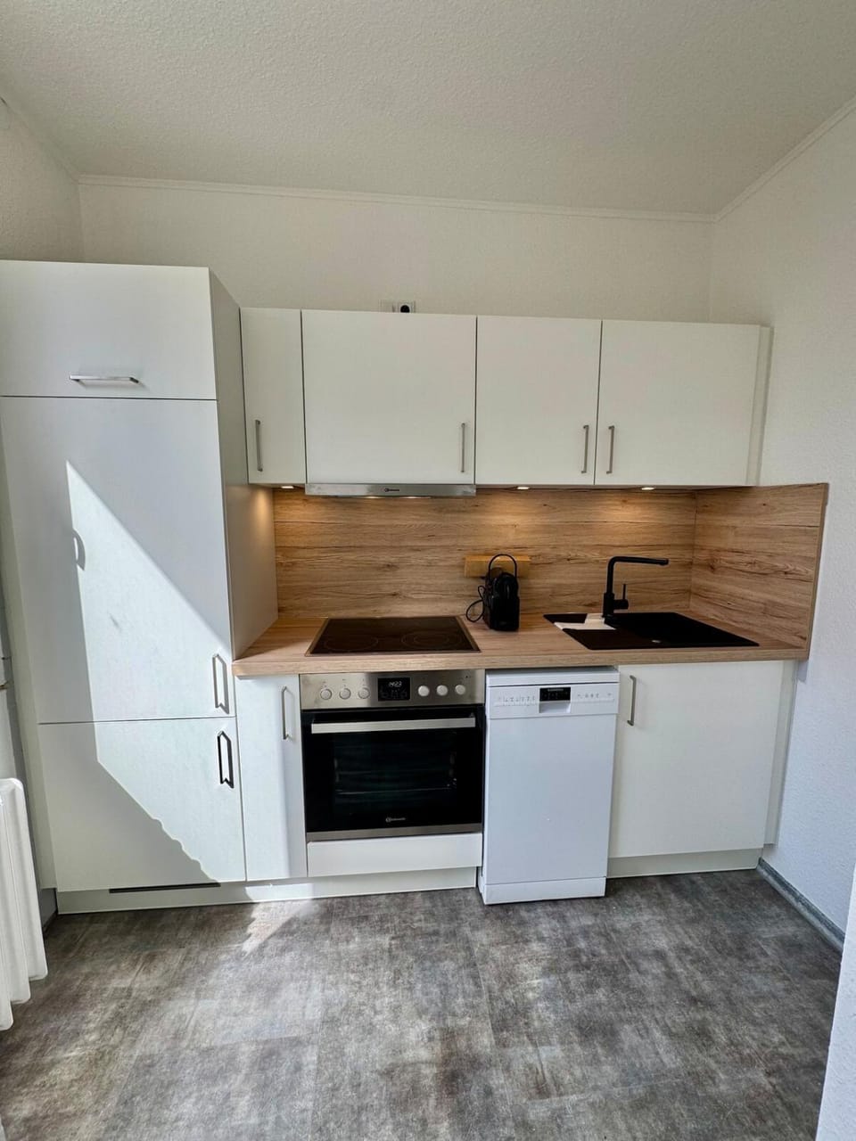 Kitchen or kitchenette, dishwasher, oven, stove
