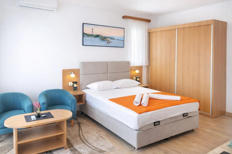 Bed, Seating area, Bedroom, towels, wardrobe, air conditioner