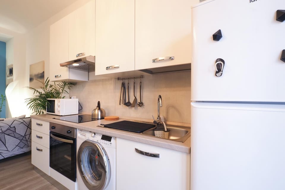 Kitchen or kitchenette, microwave, oven, stove, washing machine