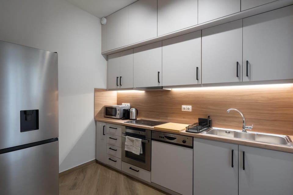 Kitchen or kitchenette, dishwasher, oven, stove