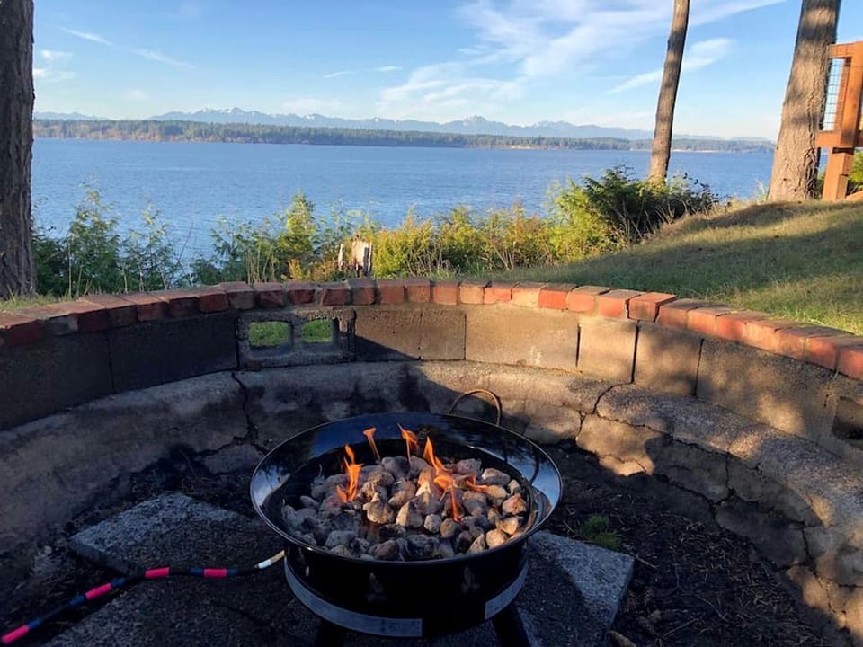 Incredible Sunset at Beachfront Glamping Cabin on Private, Herron Island with Fire Pit and Kayaking near Olympia, Washington Cabin in Herron Island