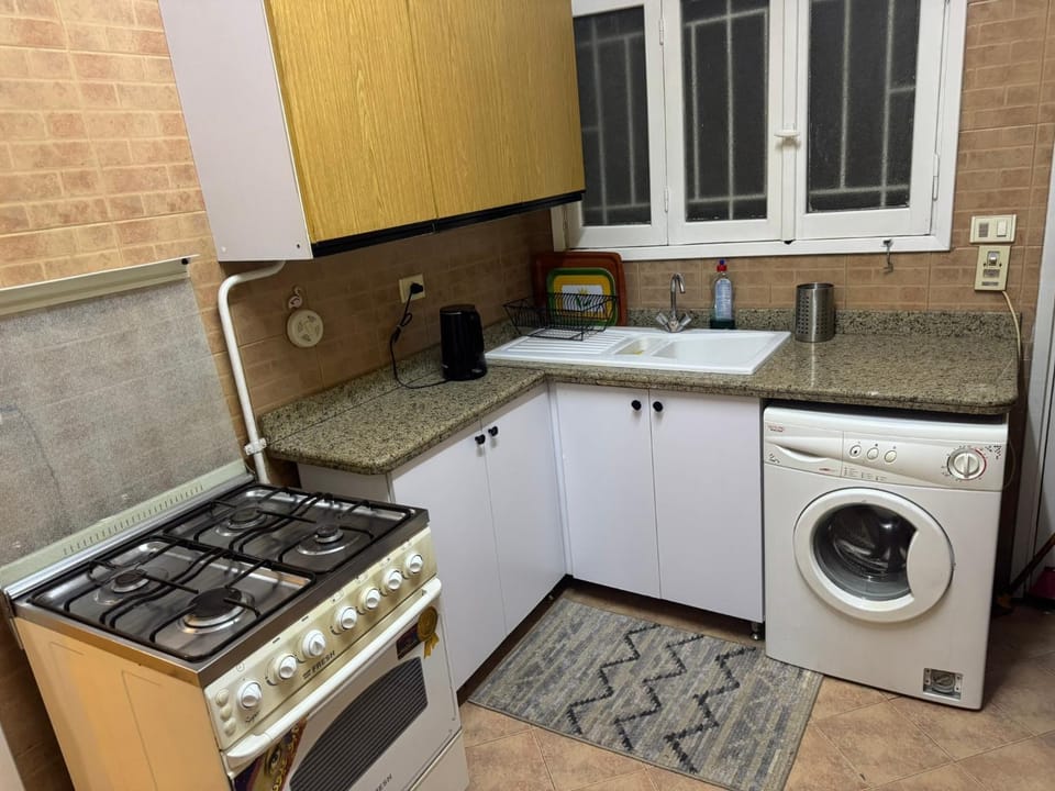 Kitchen or kitchenette, stove, washing machine