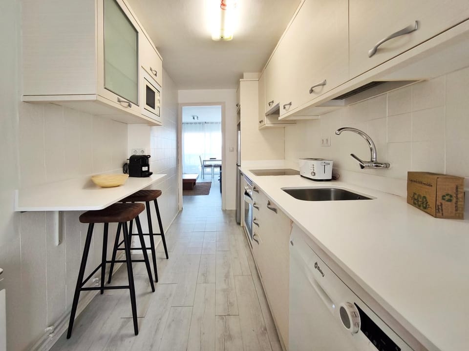Kitchen or kitchenette, dishwasher, oven, stove