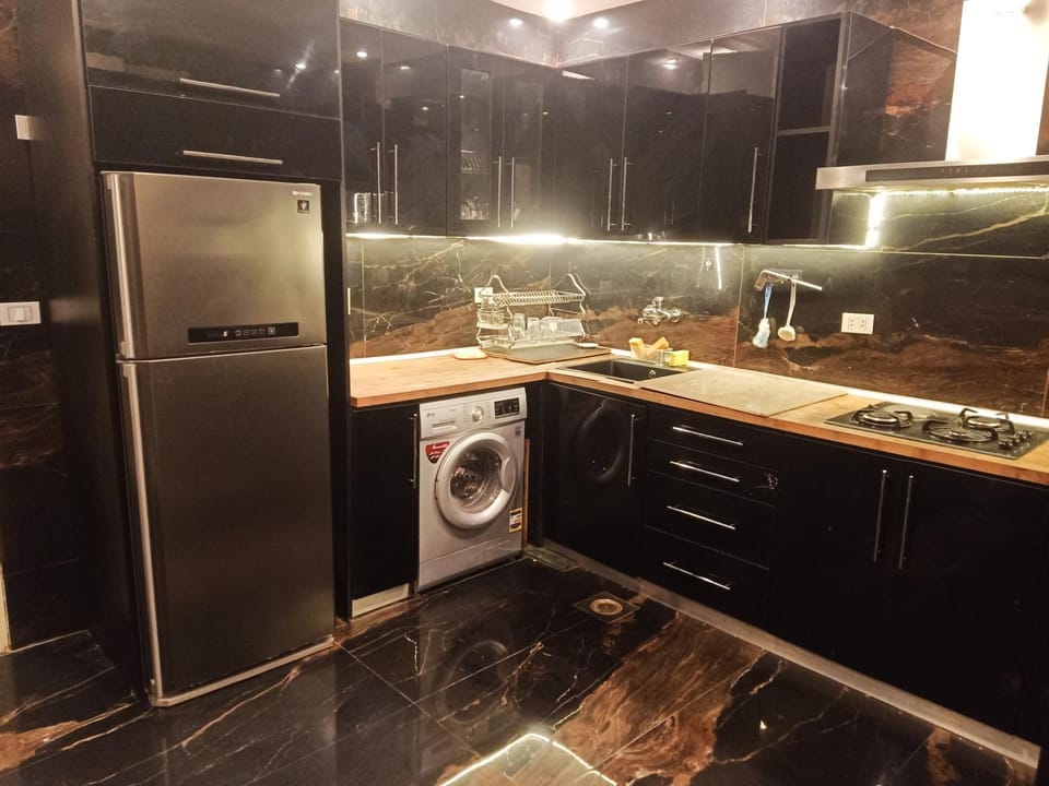 Kitchen or kitchenette, stove, washing machine, dryer