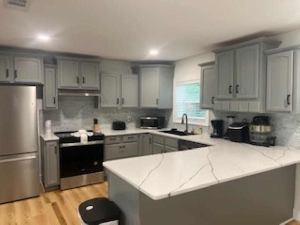 Kitchen or kitchenette, dishwasher, oven, stove