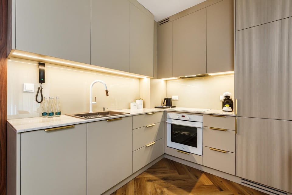 Kitchen or kitchenette, dishwasher, oven, stove