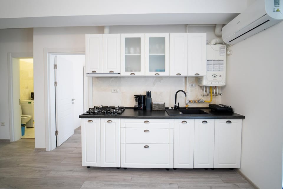 Kitchen or kitchenette, microwave, stove, air conditioner