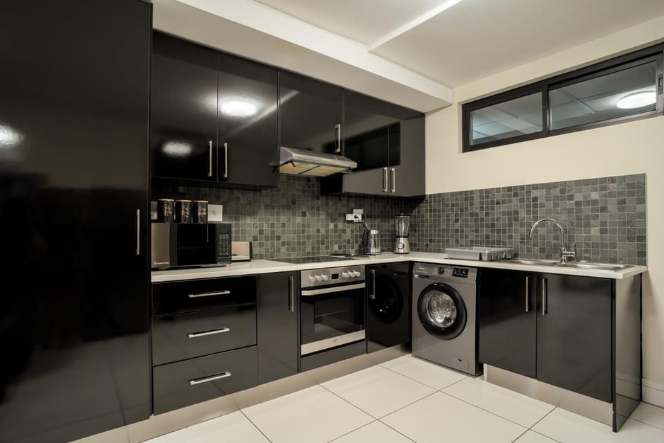 Kitchen or kitchenette, oven, stove, toaster, washing machine