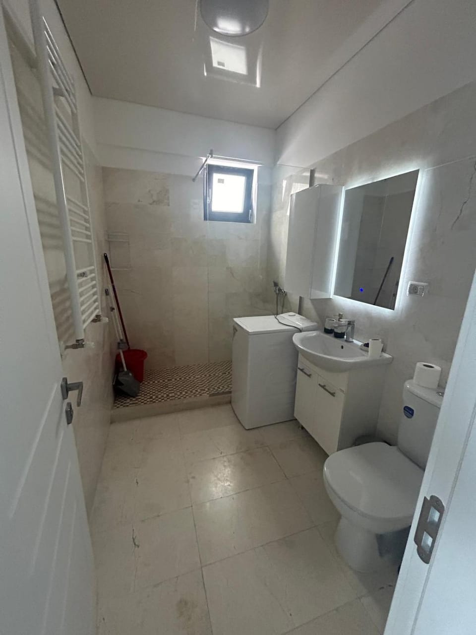 Shower, Toilet, Bathroom, hair dryier, towels, washing machine