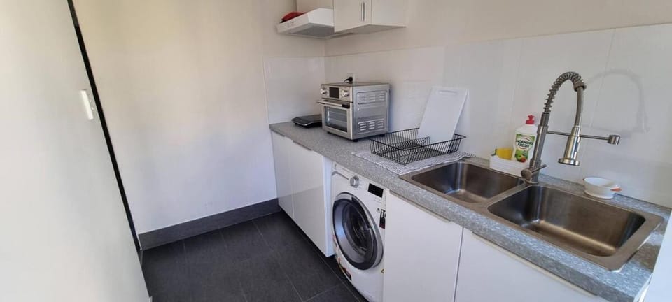 Kitchen or kitchenette, oven, stove, washing machine, dryer