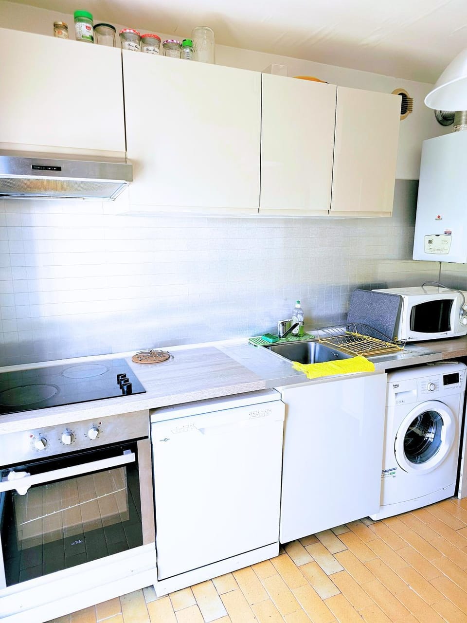 Kitchen or kitchenette, dishwasher, oven, stove, washing machine