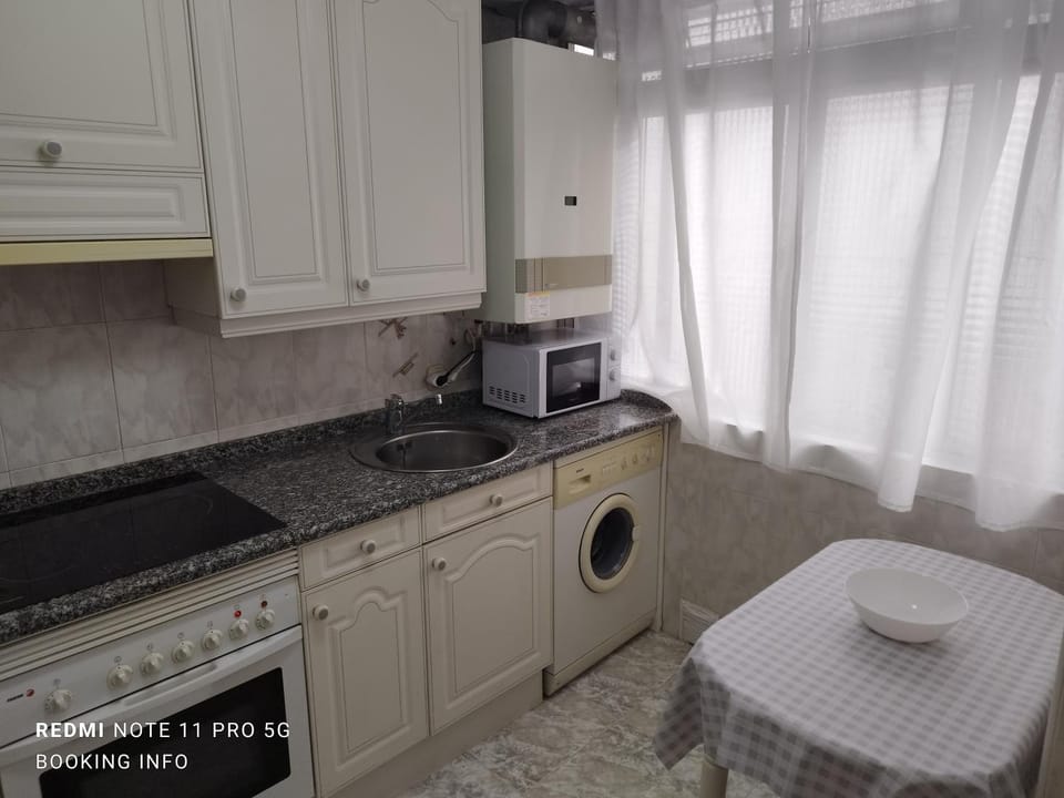 Kitchen or kitchenette, stove, toaster, washing machine