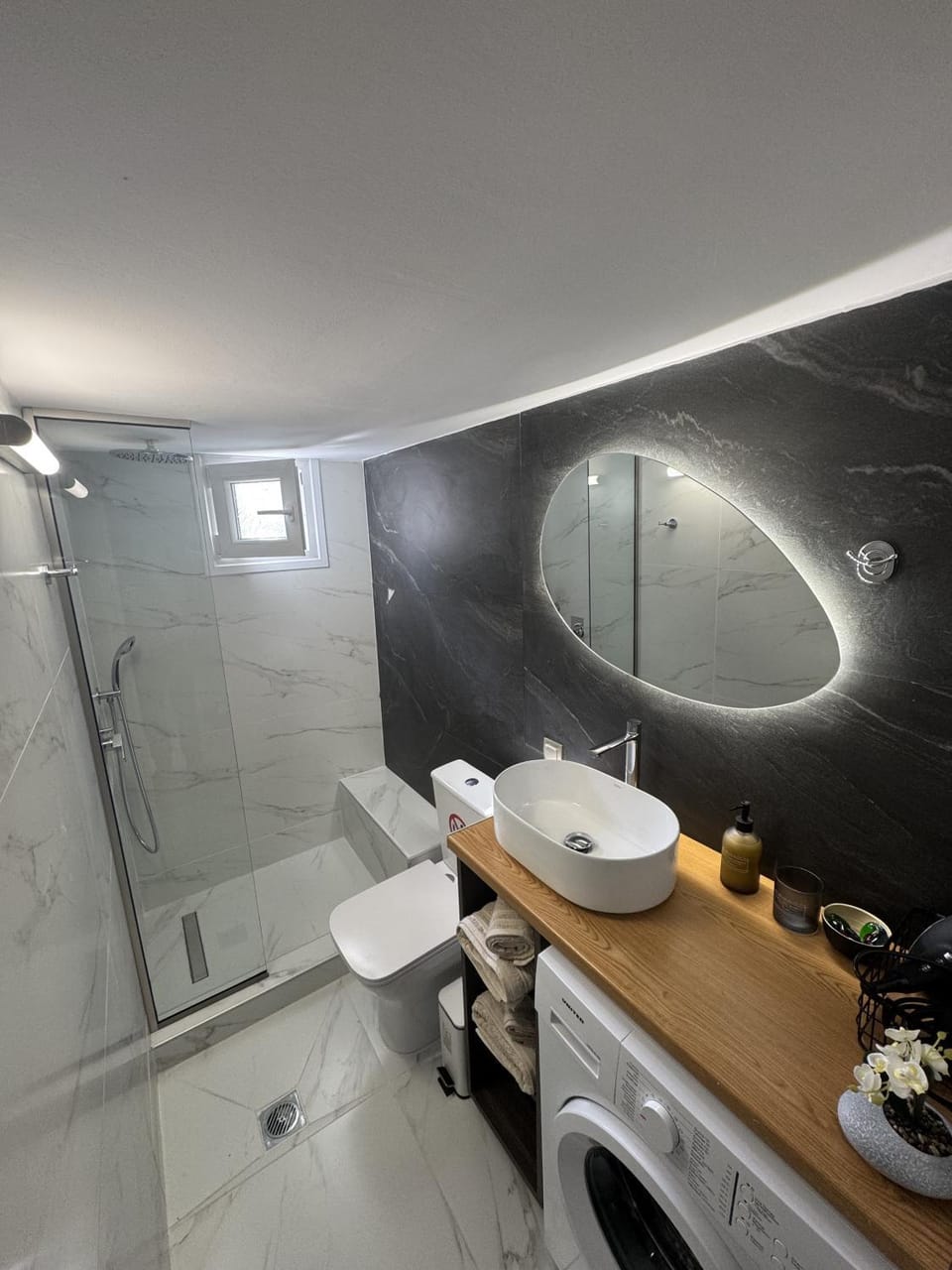 Shower, Toilet, towels, washing machine, dryer