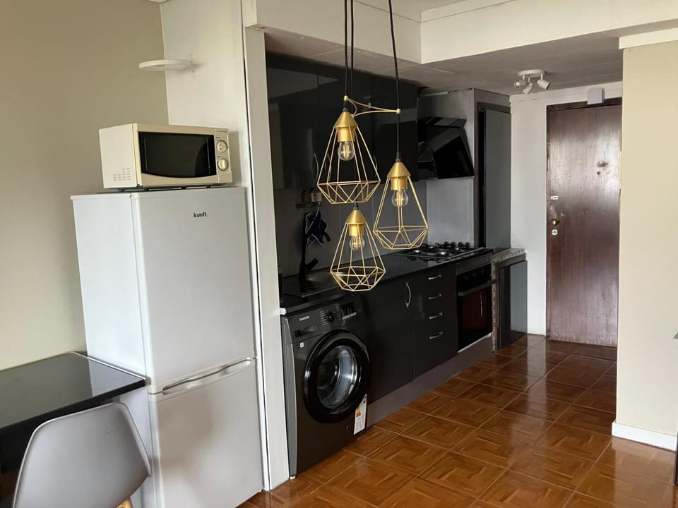 Kitchen or kitchenette, microwave, oven, stove, washing machine