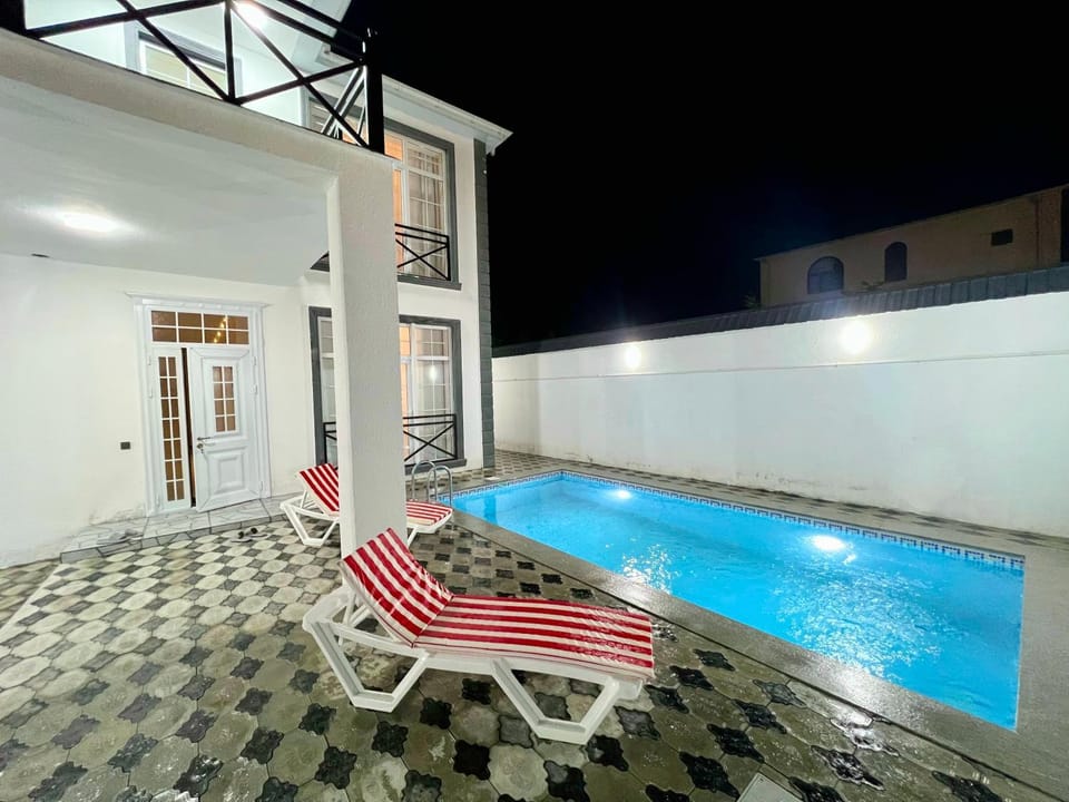 Property building, Patio, Night, Pool view, Swimming pool, sunbed