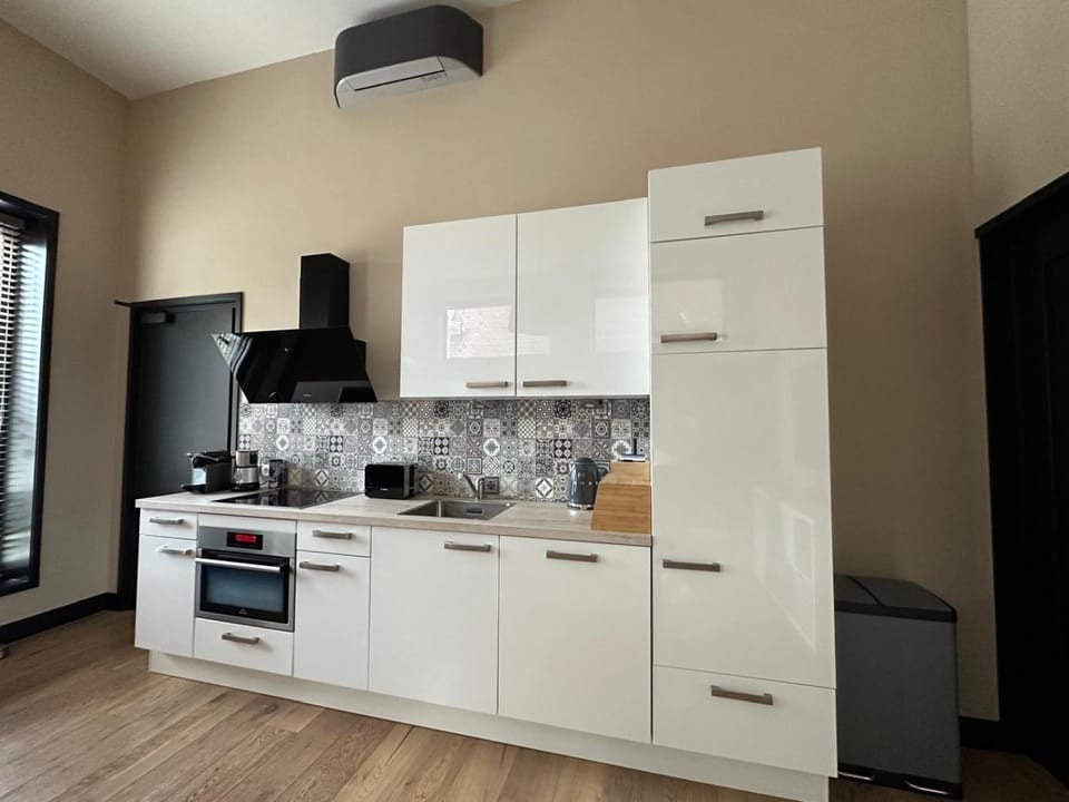 Kitchen or kitchenette, dishwasher, oven, stove, air conditioner