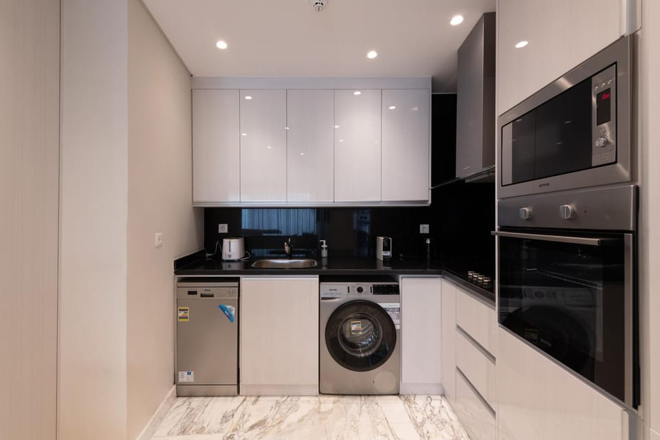 Kitchen or kitchenette, dishwasher, oven, stove, washing machine