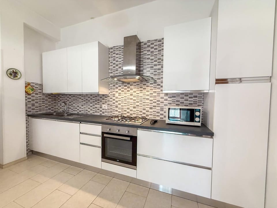 Kitchen or kitchenette, microwave, oven, stove