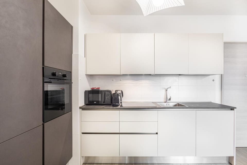 Kitchen or kitchenette, dishwasher, oven, stove