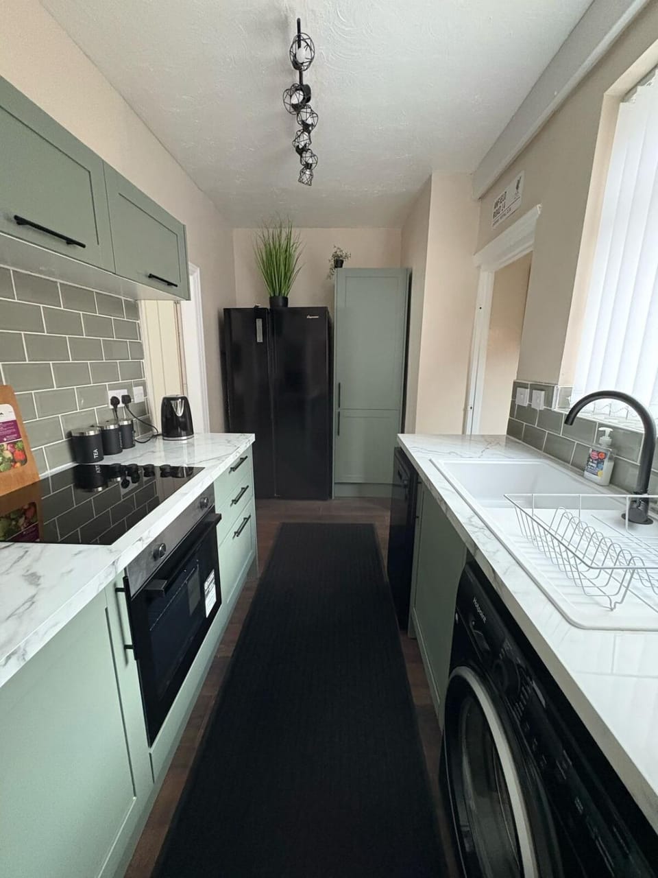 Kitchen or kitchenette, dishwasher, oven, stove