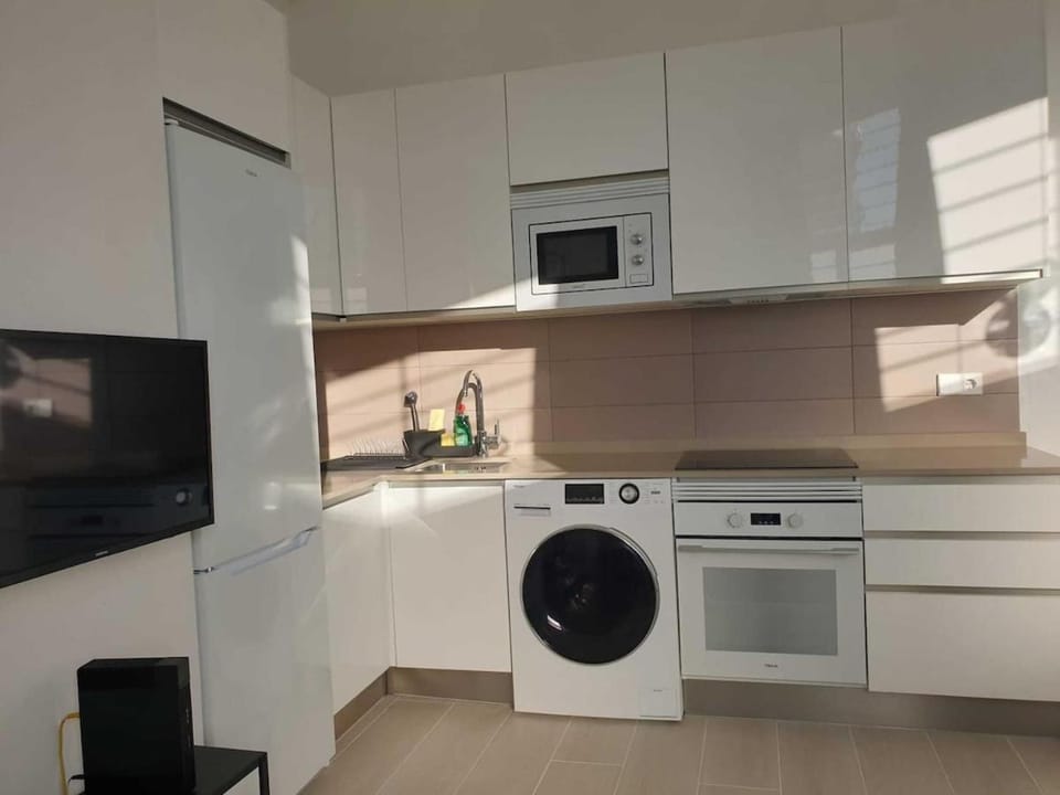 Kitchen or kitchenette, microwave, oven, stove, washing machine