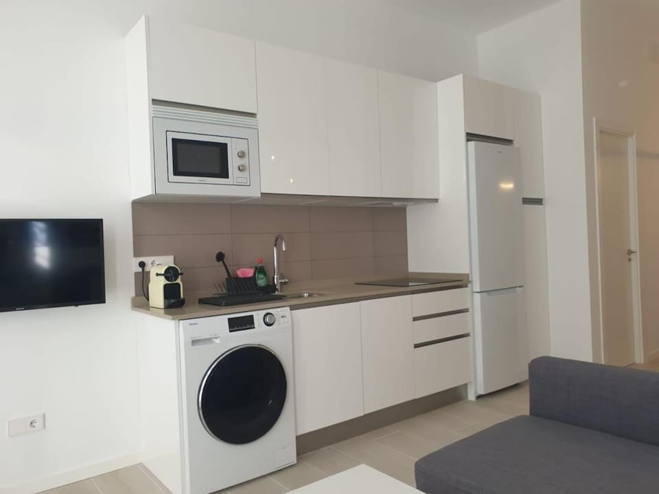 Kitchen or kitchenette, microwave, stove, washing machine