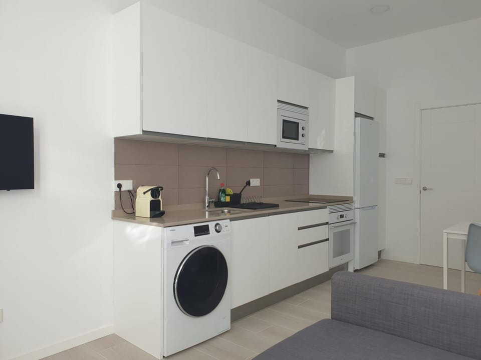 Kitchen or kitchenette, oven, stove, washing machine, dryer