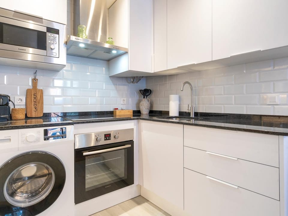 Kitchen or kitchenette, dishwasher, oven, stove, toaster, washing machine