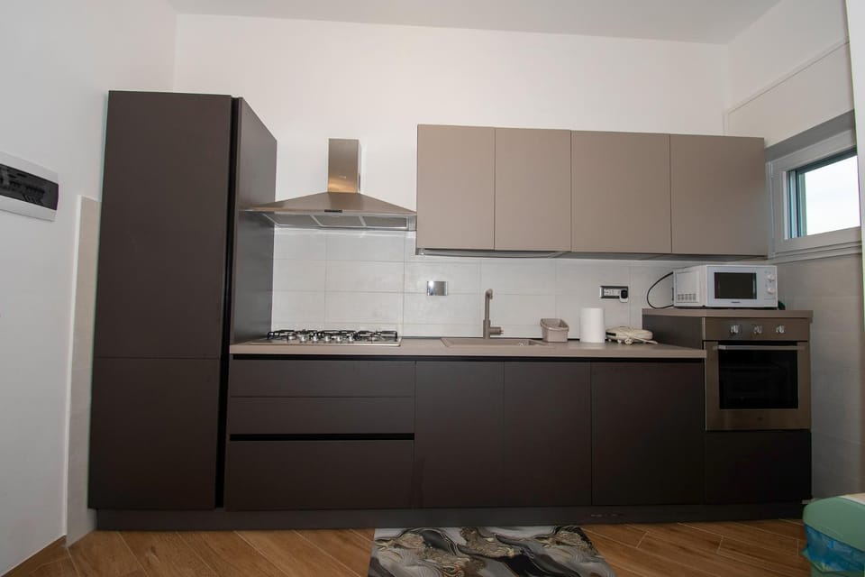 Kitchen or kitchenette, dishwasher, oven, stove
