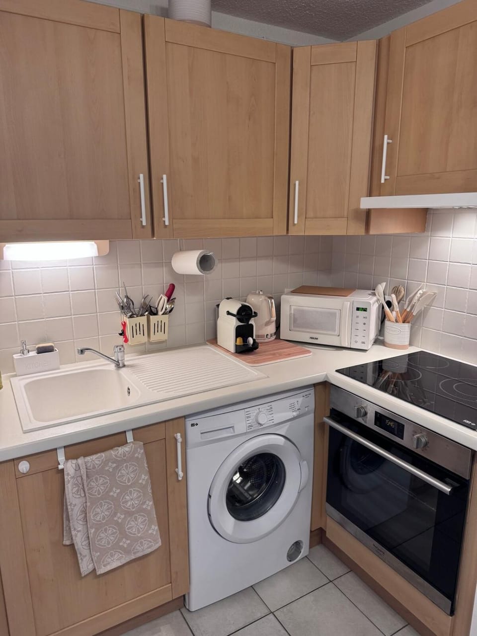 Kitchen or kitchenette, microwave, stove, toaster, washing machine