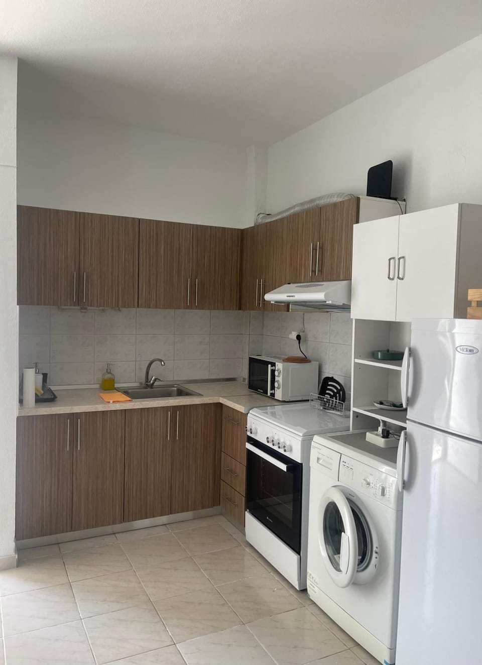 Kitchen or kitchenette, microwave, oven, stove, washing machine