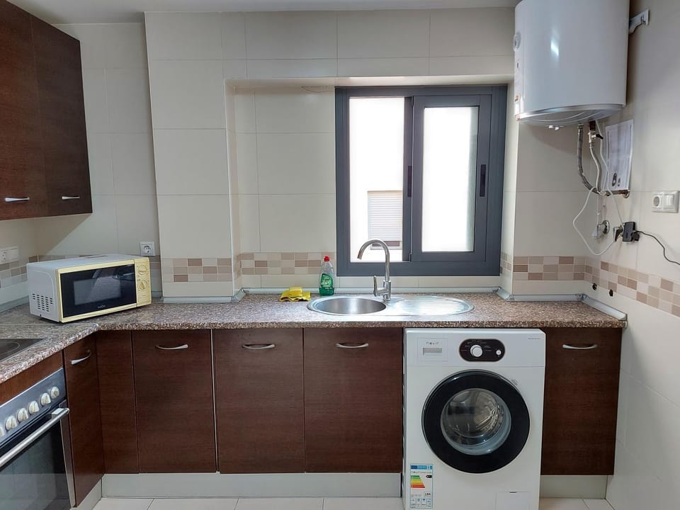 Kitchen or kitchenette, oven, stove, washing machine