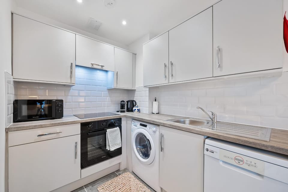 Kitchen or kitchenette, dishwasher, oven, stove, washing machine