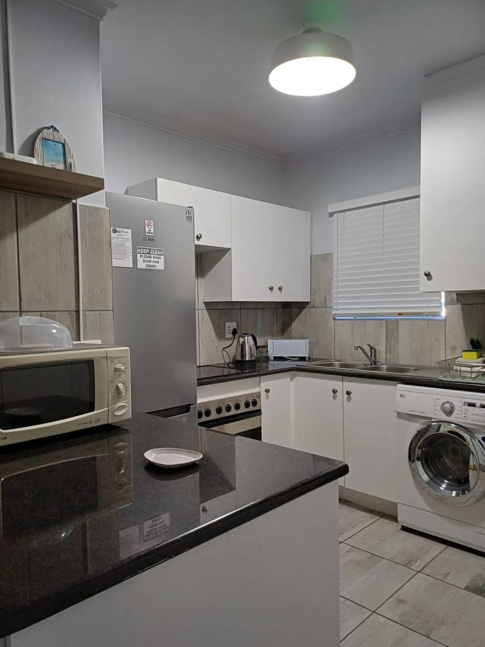 Kitchen or kitchenette, oven, stove, toaster, washing machine, dryer