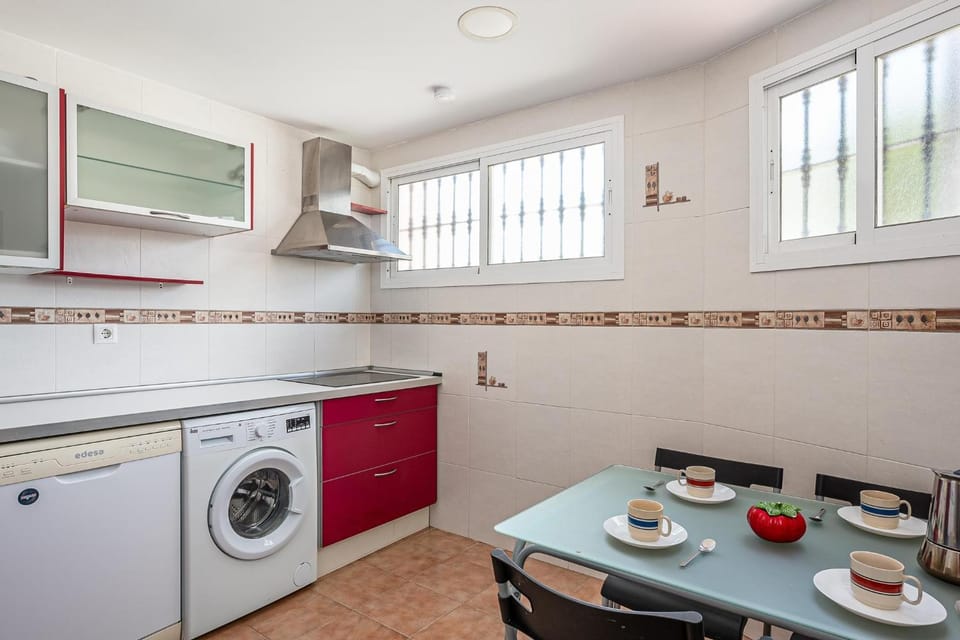 Kitchen or kitchenette, stove, toaster, washing machine