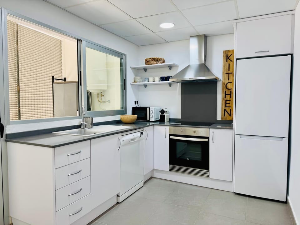 Kitchen or kitchenette, dishwasher, oven, stove